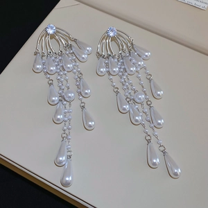 Detailed view of silver zircon tassel earrings with pearls and water drop pendants