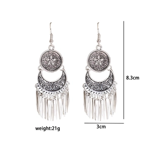 Detail view of retro silver tassel earrings with 8.3cm length and 3cm width specs