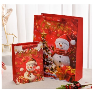 Detailed view of red Christmas gift bags with snowman and tree patterns in two sizes