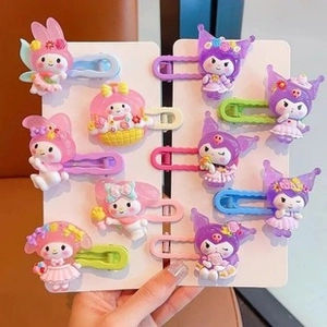 Detailed view of Kuromi and My Melody themed cartoon hair clips in pink and purple colors