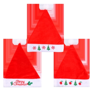 Three plush red and white Christmas hats with festive embroidery on red background