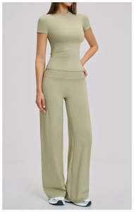 Detail of high-waist wide-leg yoga pants and short sleeve top in sage green knit