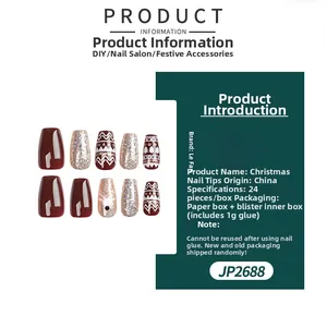 Detail of Christmas ballerina press-on nails featuring red, gold glitter and elk patterns