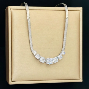 Detailed view of silver snake chain necklace featuring seven sparkling square zircons