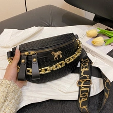 Detail of black woven chest bag with golden horse logo and jacquard wide strap