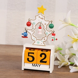 Detail of Christmas tree wooden perpetual calendar with date blocks and festive ornaments