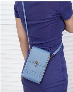 Light blue floral phone bag with multi-layer storage shown on a purple dress model