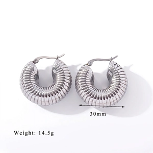 Detailed view of silver ribbed chunky hoop earrings with 30mm diameter and 14.5g weight