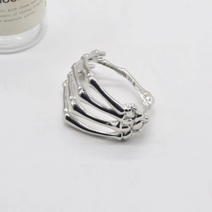 Macro detail of silver gothic skeleton hand bracelet with intricate bone joints and finish