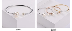 Detail of open pearl bangle in gold, rose gold and silver stainless steel finishes
