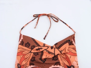 Detail of bohemian paisley print halter top with neck tie in brown and orange tones