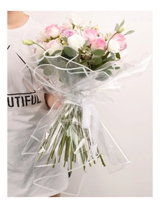 Detail of waterproof OPP flower wrapping paper with white borders on a rose bouquet