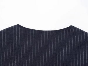 Close-up of the neckline on a navy blue striped linen vest with detailed sewing craft