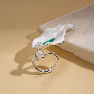 Detail of irregular white enamel wavy petal ring with green center and two pearls