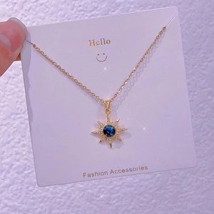 Dettaglio macro della collana con ciondolo a sole, pietra galassia blu e piccoli cristalli