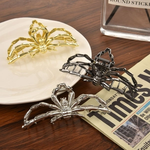 Detailed close-up of alloy spider hair claws in gold, silver, and gunmetal finishes