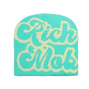 Detail of mint green and cream knit beanie featuring street style Rich Mob jacquard text
