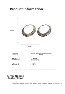 Detail view of large 925 silver needle hoop earrings with luxury rhinestone inlay