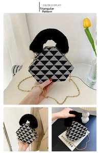 Detail of a geometric bag with black and white triangle patterns and faux fur handle