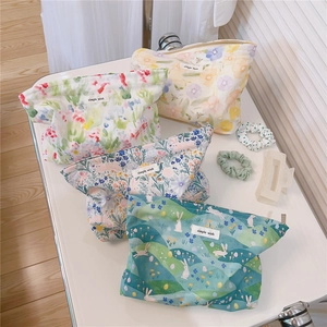 Collection of four patterned cotton makeup bags with floral and bunny prints