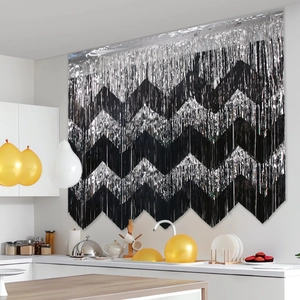 Silver and black wavy party fringe curtain backdrop with balloon decorations for birthdays