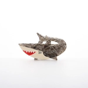Detailed view of a shark-shaped hair claw clip made of tortoiseshell acetate material