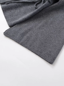 Detail of dark gray knit fabric with fine ribbed texture and drawstring waistband