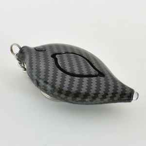 Close-up of black carbon fiber leaf alarm keychain with LED light and metal ring detail