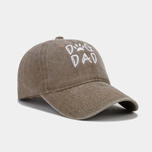 Detailed embroidery of DOG DAD text and paw print on khaki washed cotton baseball cap