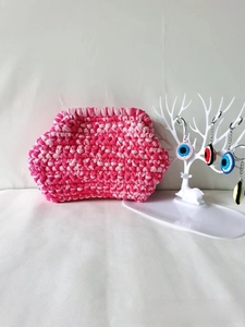 Detail of pink gradient handmade crochet cloud bag with colorful evil eye keychains