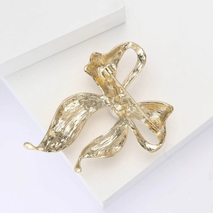 Detailed back view of the golden alloy brooch showing the secure pin fastener mechanism