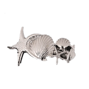 Ocean themed silver starfish and seashell alloy hair clips with textured metal surface