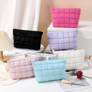 Detailed group shot of quilted makeup bags in multiple colors with stylish accessories