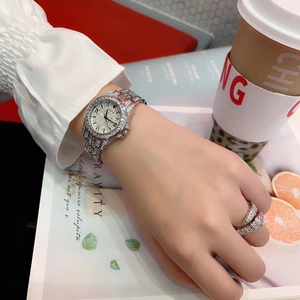 Lifestyle shot of silver crystal-encrusted watch and ring set on an elegant model's hand