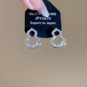 Detail of silver hollow gourd earrings with cubic zirconia and 1000 silver hallmark