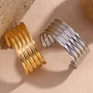 Detail of multi-layer wavy wide open cuff bracelet in 18K gold and silver finishes