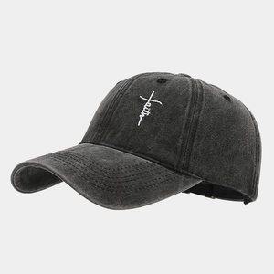 Close-up of cross-shaped faith embroidery on a dark grey washed denim baseball cap