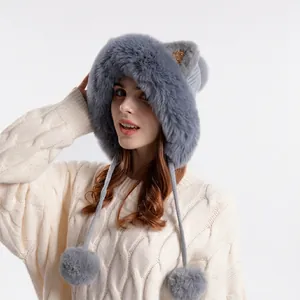 Winter faux fur trapper hat with cute cat ears and pom-poms for women in soft grey