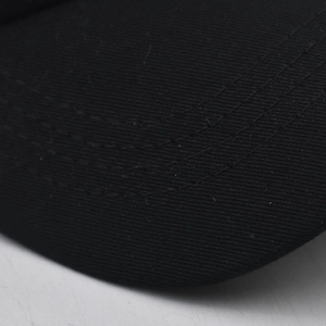 Close-up of the detailed multi-row stitching on the black washed cotton baseball cap brim