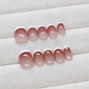 Short square French press-on nails with nude gradient base and classic white tips