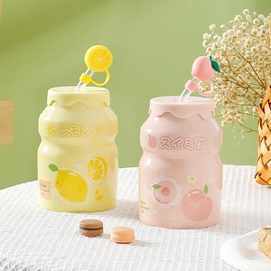 Minimalist ceramic mugs set in lemon and peach themes with matching fruit straw covers