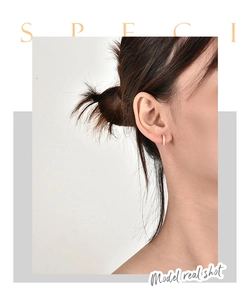 Model real shot of gold hoop earrings with small crystals and huggie style