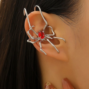 Close-up of gothic silver spider ear cuff with a red gemstone on the model's ear