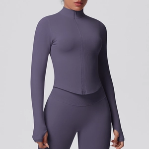 Close-up of purple ribbed yoga jacket featuring stand collar, zipper, and thumbhole cuffs