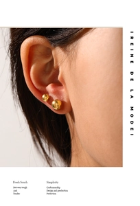 Close-up of minimalist gold ball earrings set showing polished mirror finish and texture