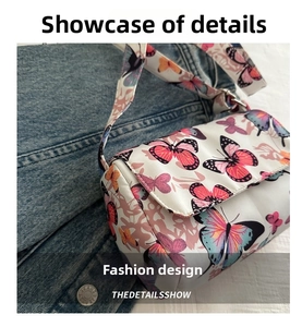 Detail view of colorful butterfly print on stylish mini square bag with matching strap