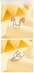Detailed view of cat ear cuff with pink enamel and sparkling white zircon stones