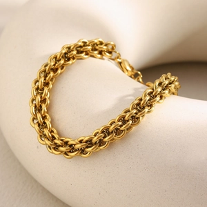 Detailed view of an 18K gold plated lantern link chain bracelet on a white plaster stand