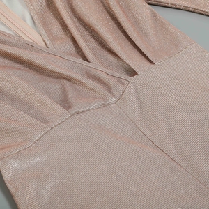 Close-up of champagne pink glitter knit fabric featuring V-neck and invisible zipper
