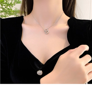 Close-up of double interlocking rings necklace on a model wearing black velvet